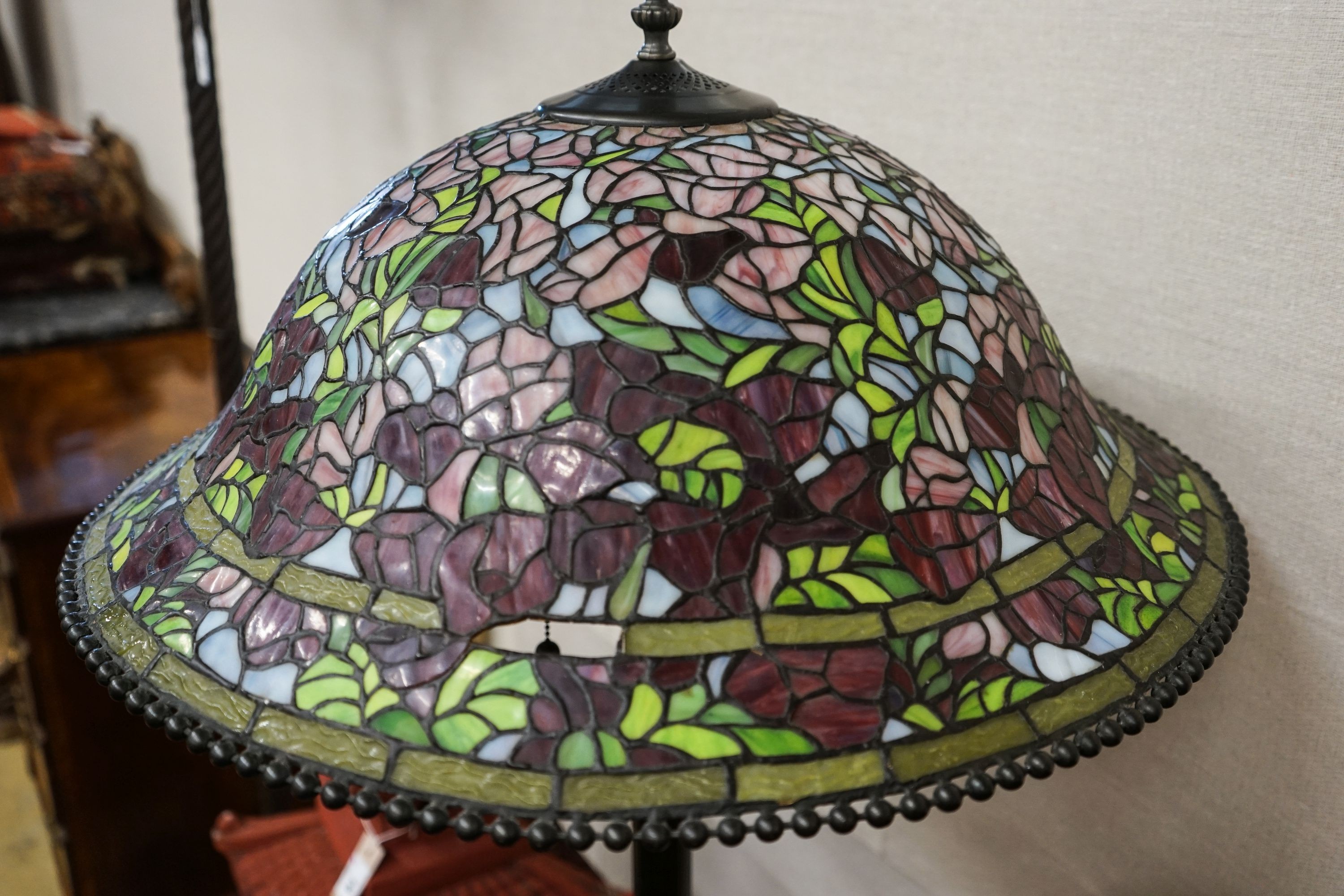 A bronzed finish Tiffany style standard lamp with shade, 160cm high, 59cm diameter